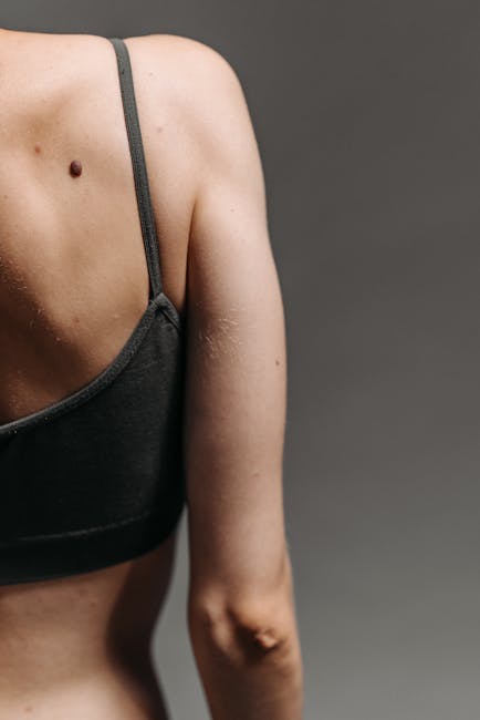 Close-up of a person's back muscles engaging during a core-strengthening yoga pose